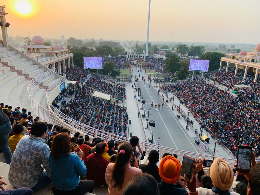Wagah Border flag-lowering ceremony with cheering crowds"